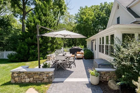 a view of a patio with chairs and plants