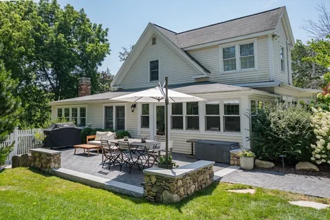 a view of a house with furniture and garden