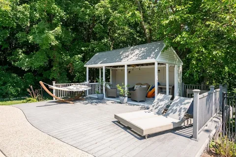 a view of backyard with swimming pool and sitting area