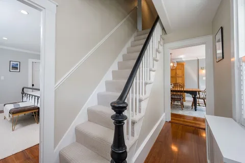 a view of entryway and hall with wooden floor
