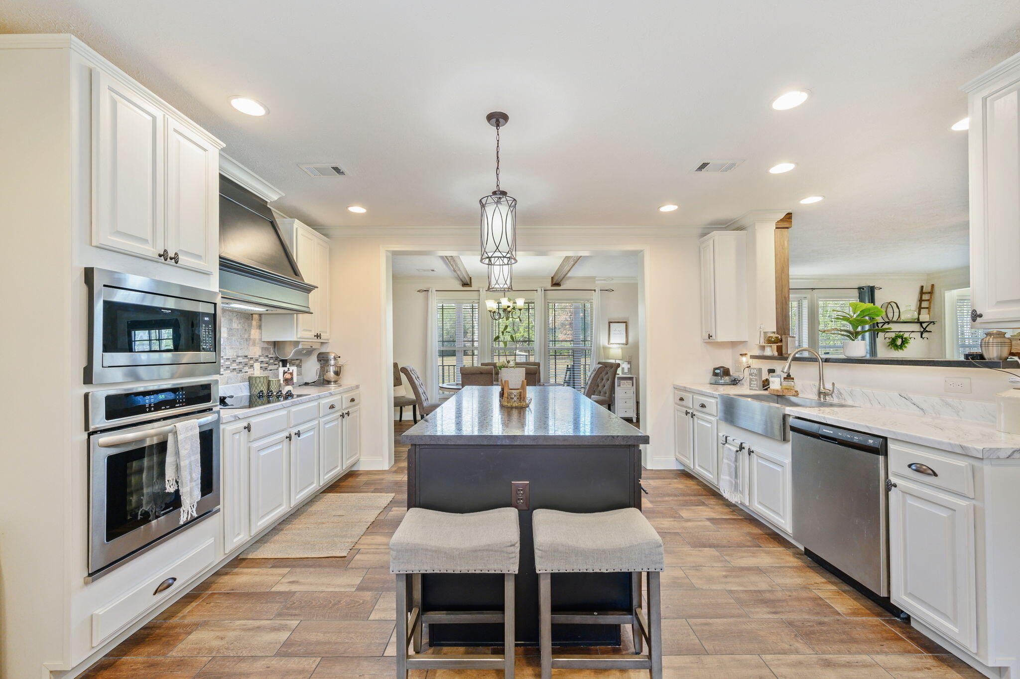 6019 Old River Road Baker, FL 32531 - Photo 13 of 54 a kitchen with stainless steel appliances granite countertop a stove top oven a sink dishwasher a dining table and chairs