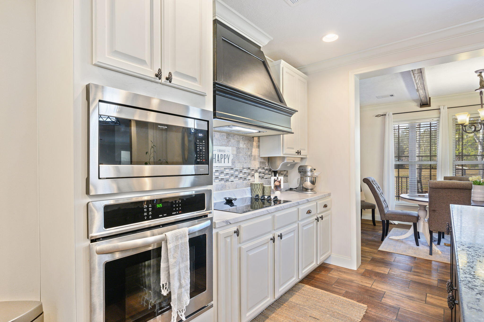 6019 Old River Road Baker, FL 32531 - Photo 16 of 54 a kitchen with stainless steel appliances white cabinets and white appliances
