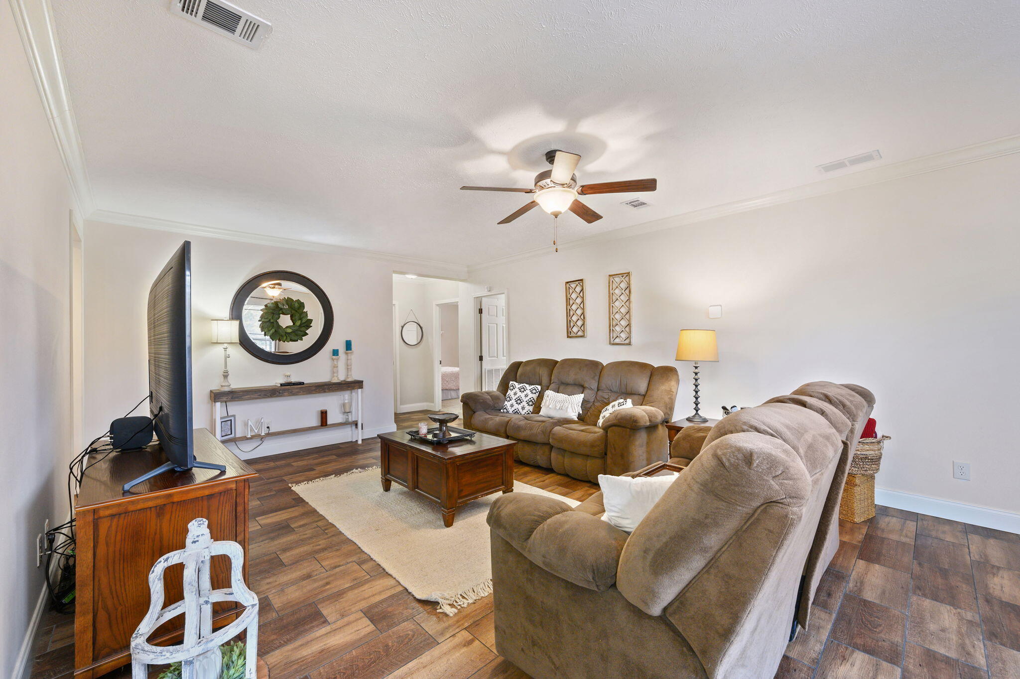 6019 Old River Road Baker, FL 32531 - Photo 27 of 54 a living room with furniture a clock and a lamp