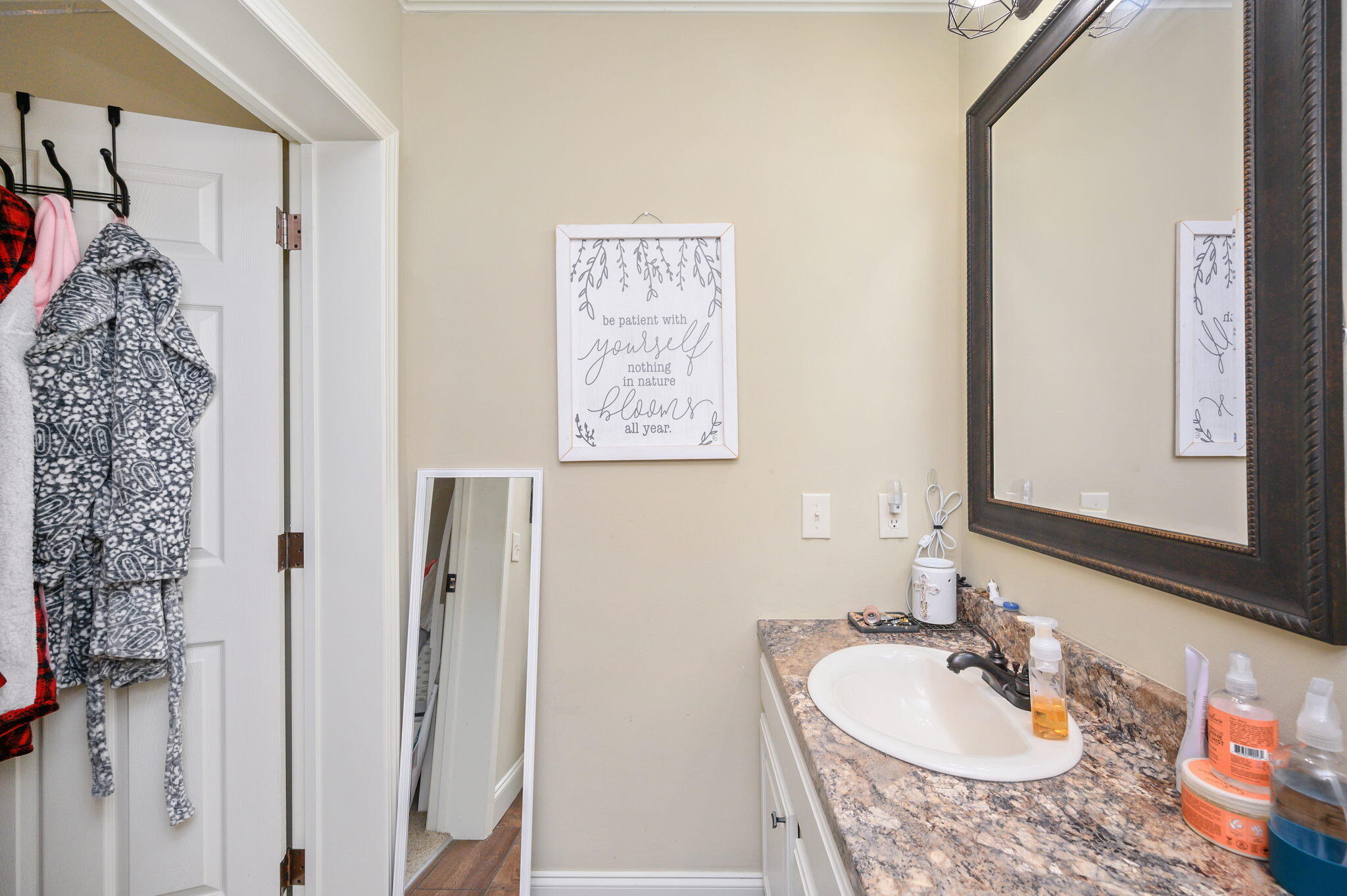 6019 Old River Road Baker, FL 32531 - Photo 31 of 54 a bathroom with a granite countertop sink and a mirror