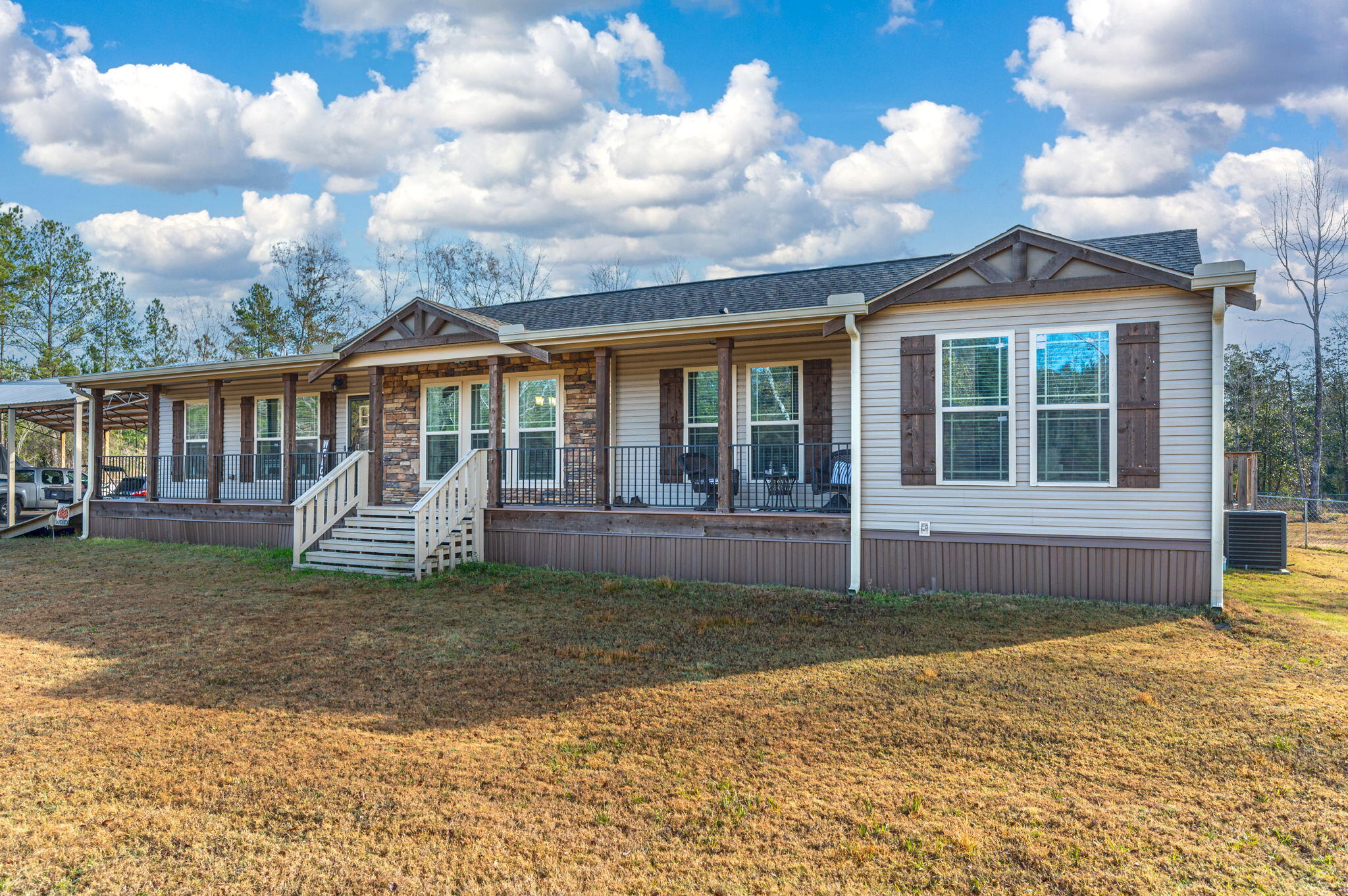 6019 Old River Road Baker, FL 32531 - Photo 4 of 54 a front view of a house with a garden