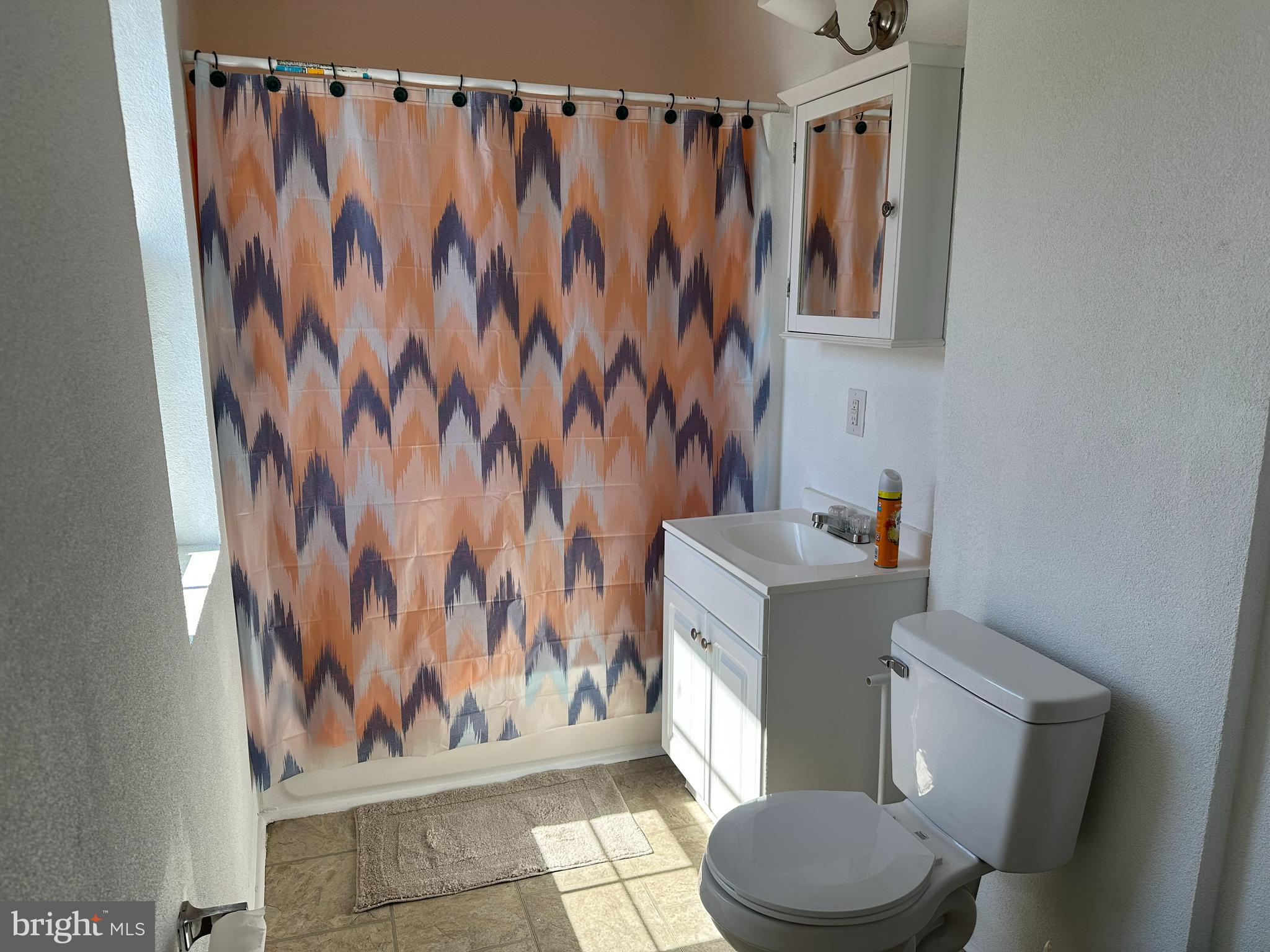 3 Harvin Road Upper Darby, PA 19082 - Photo 8 of 17 a white toilet sitting next to a shower curtain