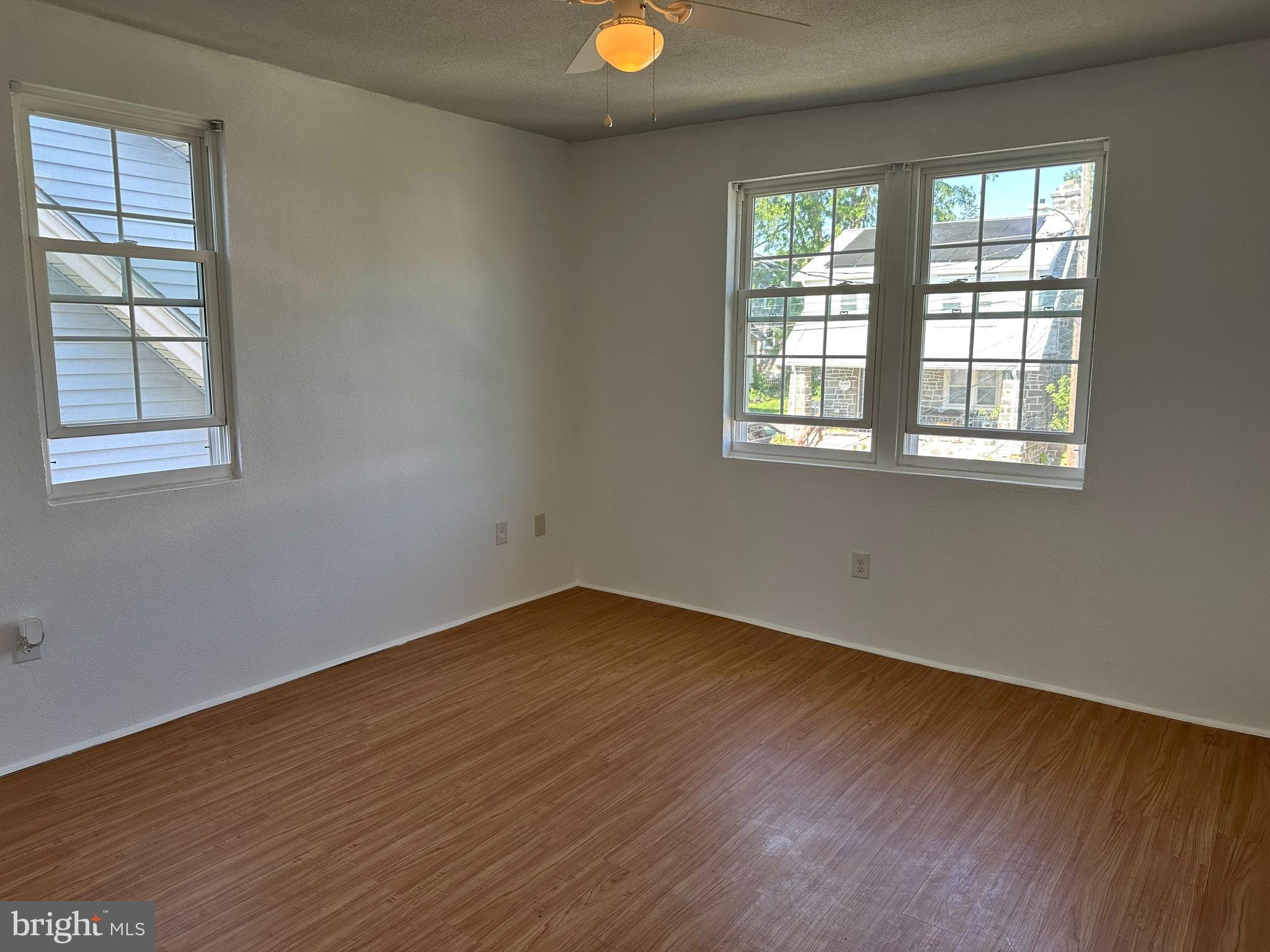 3 Harvin Road Upper Darby, PA 19082 - Photo 10 of 17 an empty room with wooden floor and windows