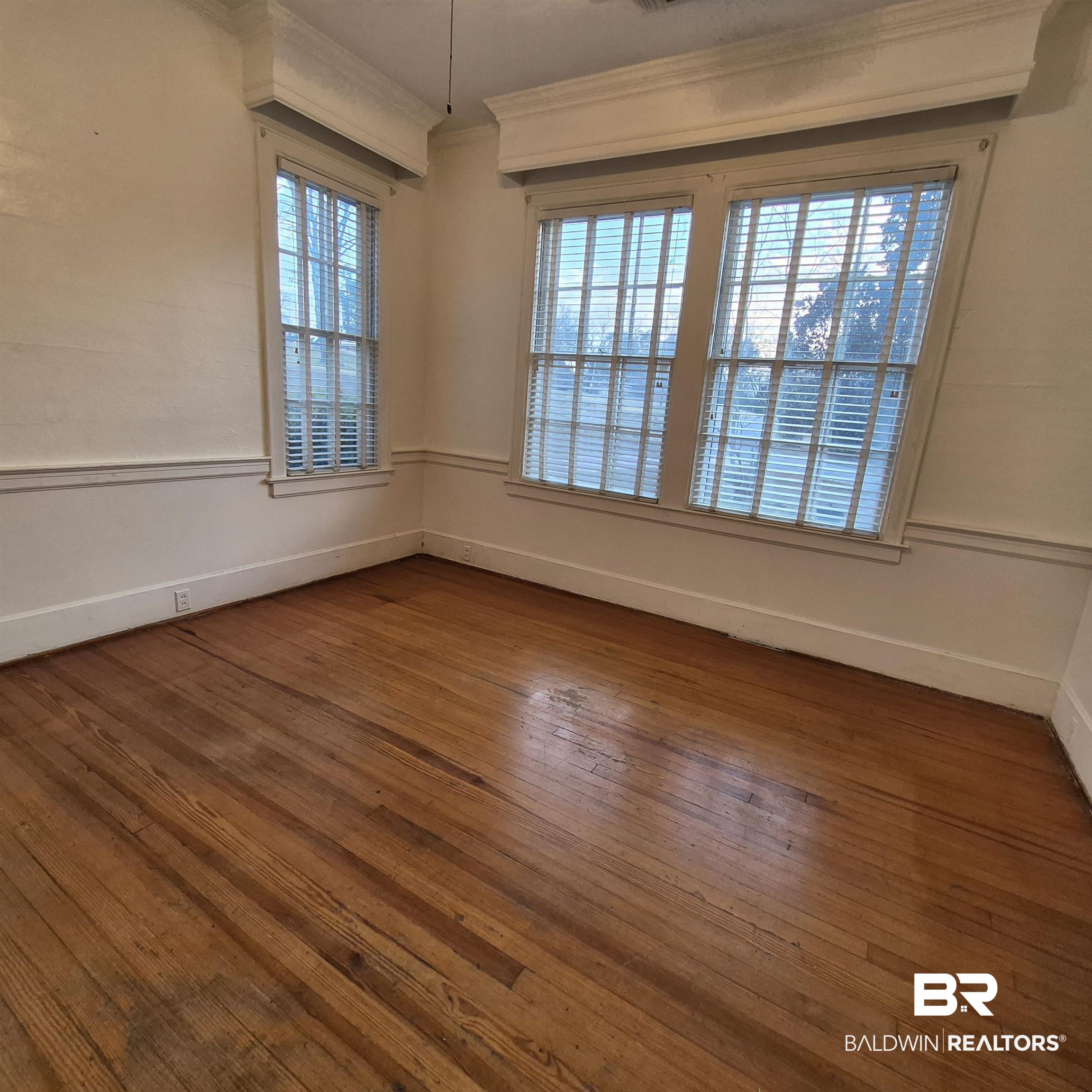 308 Rural Street Evergreen, AL 36401 - Photo 10 of 40 Unfurnished room with wood-type flooring and ornamental molding
