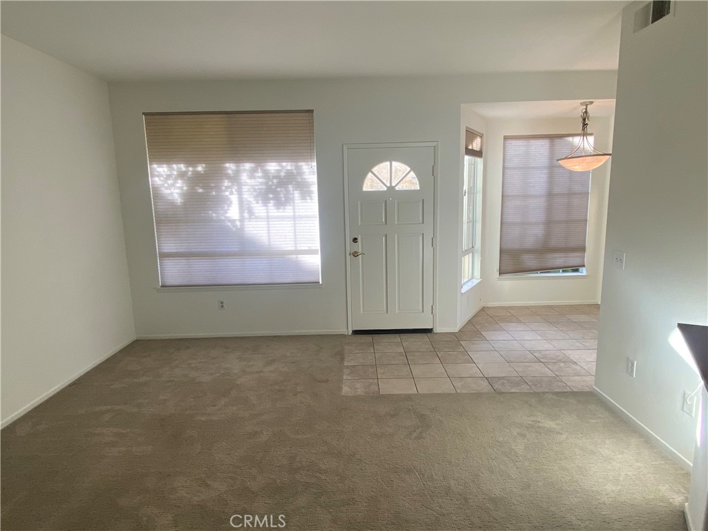 104 Costero Aisle, Unit 290 Irvine, CA 92614 - Photo 12 of 14 an empty room with window bathroom and hallway