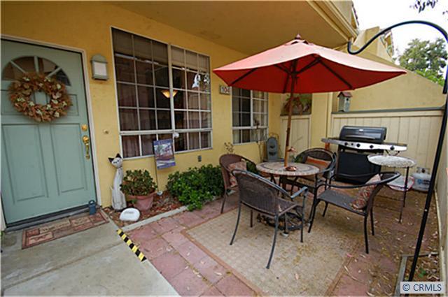 104 Costero Aisle, Unit 290 Irvine, CA 92614 - Photo 2 of 14 a patio with a table and chairs under an umbrella