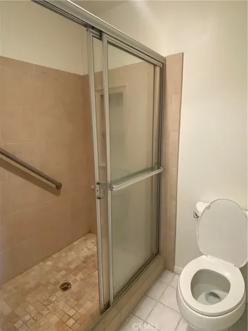 a bathroom with a granite countertop toilet and a sink