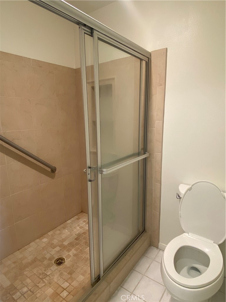 104 Costero Aisle, Unit 290 Irvine, CA 92614 - Photo 10 of 14 a bathroom with a granite countertop toilet and a sink