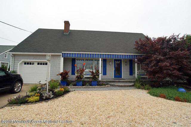 203 Helm Road Mantoloking, NJ 08738 - Photo 1 of 42 a front view of a house with garden