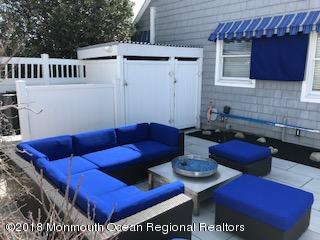 203 Helm Road Mantoloking, NJ 08738 - Photo 17 of 42 a view of a chairs and table in a patio