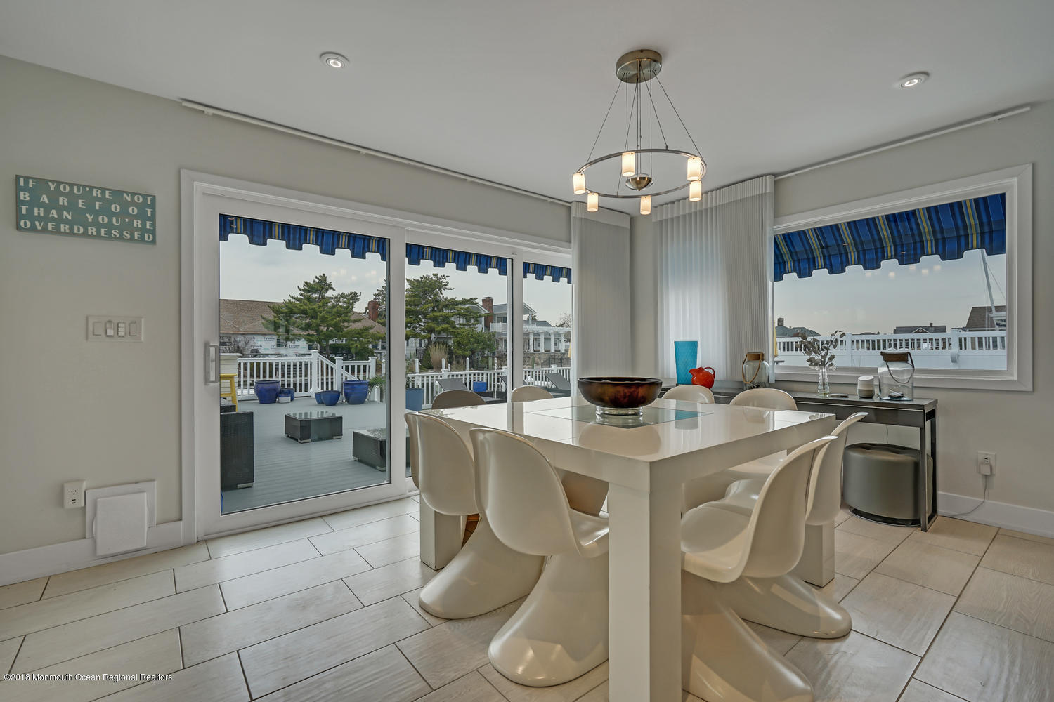 203 Helm Road Mantoloking, NJ 08738 - Photo 7 of 42 a view of a dining room with furniture a chandelier and window