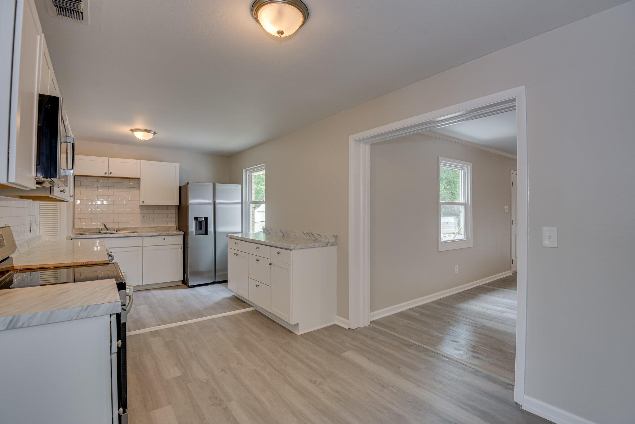 2115 Ashley Drive Augusta, GA 30906 - Photo 11 of 38 a kitchen with white cabinets and wooden floor