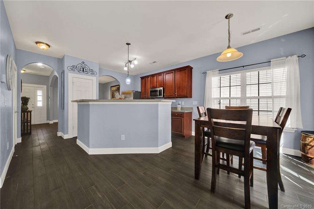 778 Jones Branch Road Fort Mill, SC 29715 - Photo 14 of 44 a view of a dining room with furniture a kitchen and chandelier