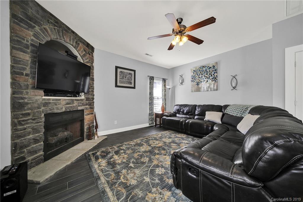 778 Jones Branch Road Fort Mill, SC 29715 - Photo 18 of 44 a living room with furniture a flat screen tv and a fireplace