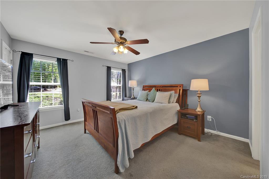778 Jones Branch Road Fort Mill, SC 29715 - Photo 21 of 44 a bedroom with a large bed and a chandelier