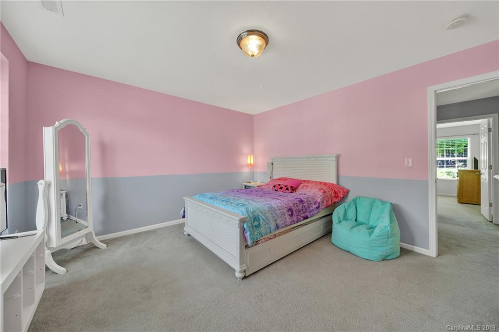 778 Jones Branch Road Fort Mill, SC 29715 - Photo 33 of 44 a bedroom with a bed and a chandelier