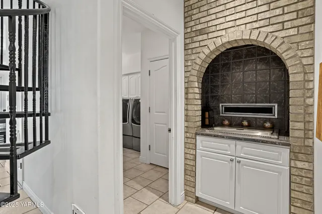 a living room with furniture and a book shelf