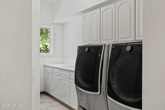 a view of a workspace with furniture and a flat screen tv