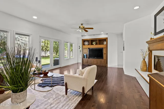 an aerial view of residential houses with outdoor space and trees