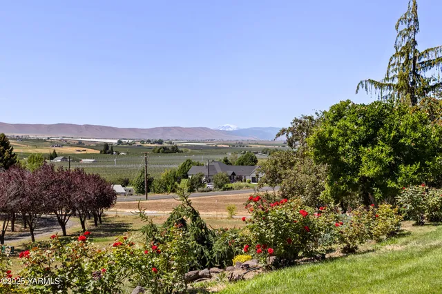 a view of a house with swimming pool and a chairs