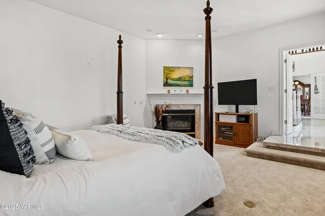 a kitchen with stainless steel appliances granite countertop a stove top oven a sink a refrigerator and white cabinets