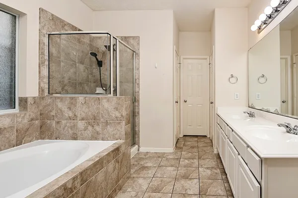 a bathroom with a bathtub and a sink