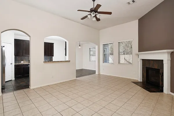 a view of an empty room with window and cabinet