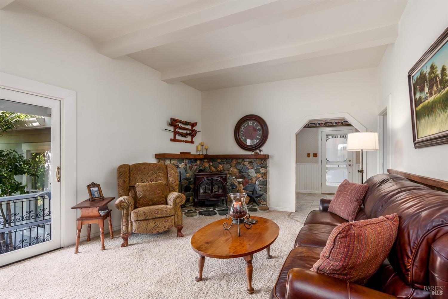 5700 Old River Road Ukiah, CA 95482 - Photo 24 of 56 a living room with furniture a rug and a fireplace