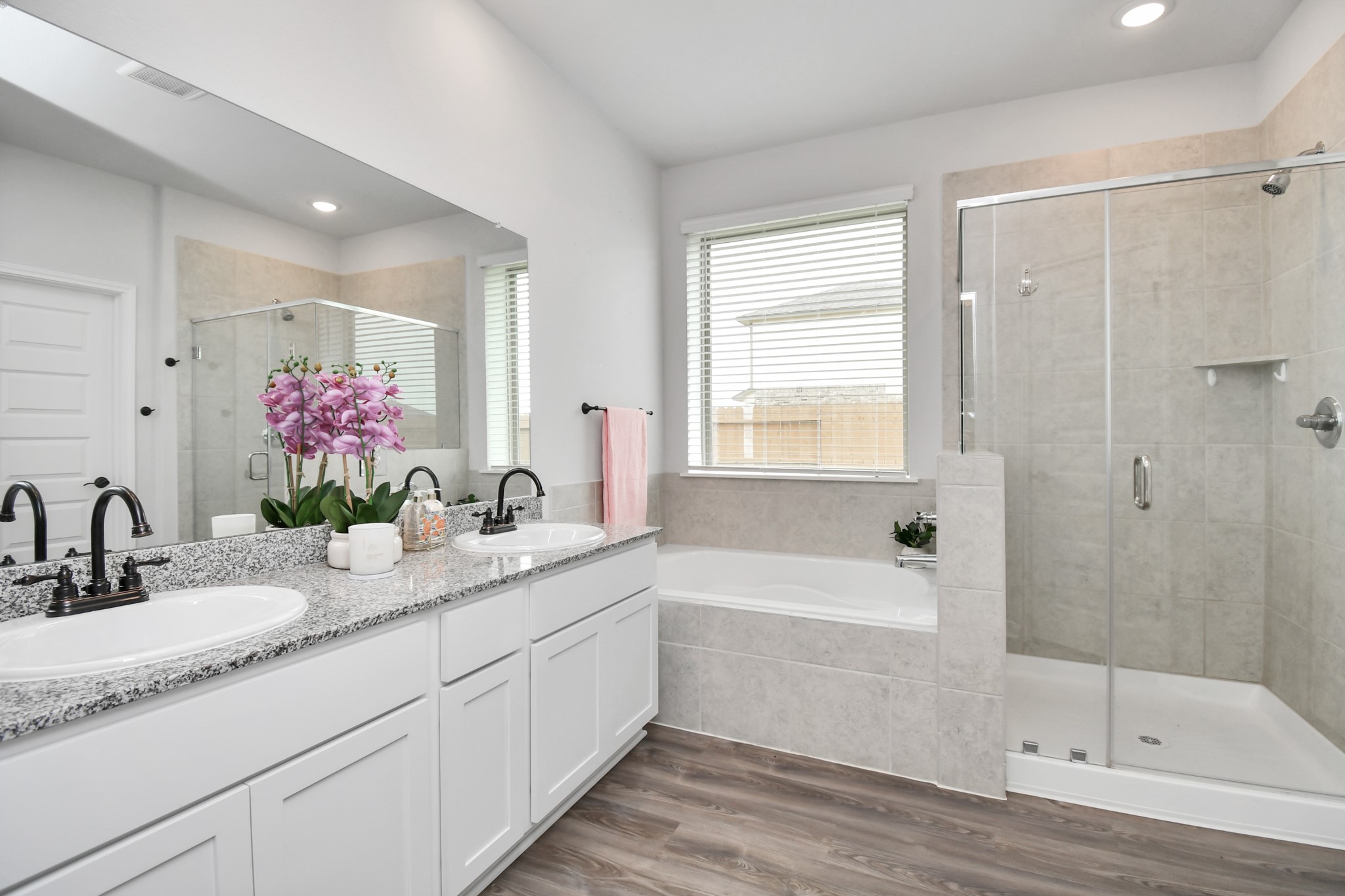 395 Hunter Ranch Way Dayton, TX 77535 - Photo 9 of 11 Primary bathroom with dual vanities, soaking tub and separate shower
