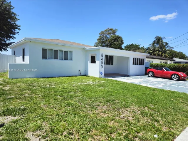 a front view of house with yard and trees