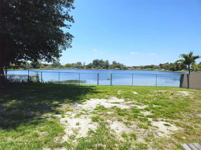 a view of yard with swimming pool and seating
