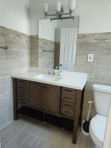 a bathroom with a sink toilet and mirror