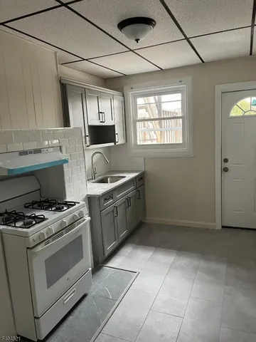 a kitchen with a stove a sink and a refrigerator