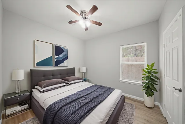 a bedroom with a bed and a potted plant