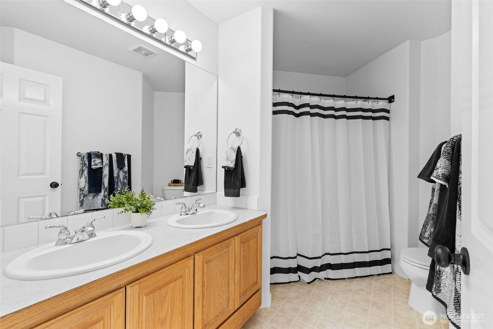 8425 Smugglers Cove Lane Mukilteo, WA 98275 - Photo 25 of 40 a bathroom with a double vanity sink a mirror a vanity and shower