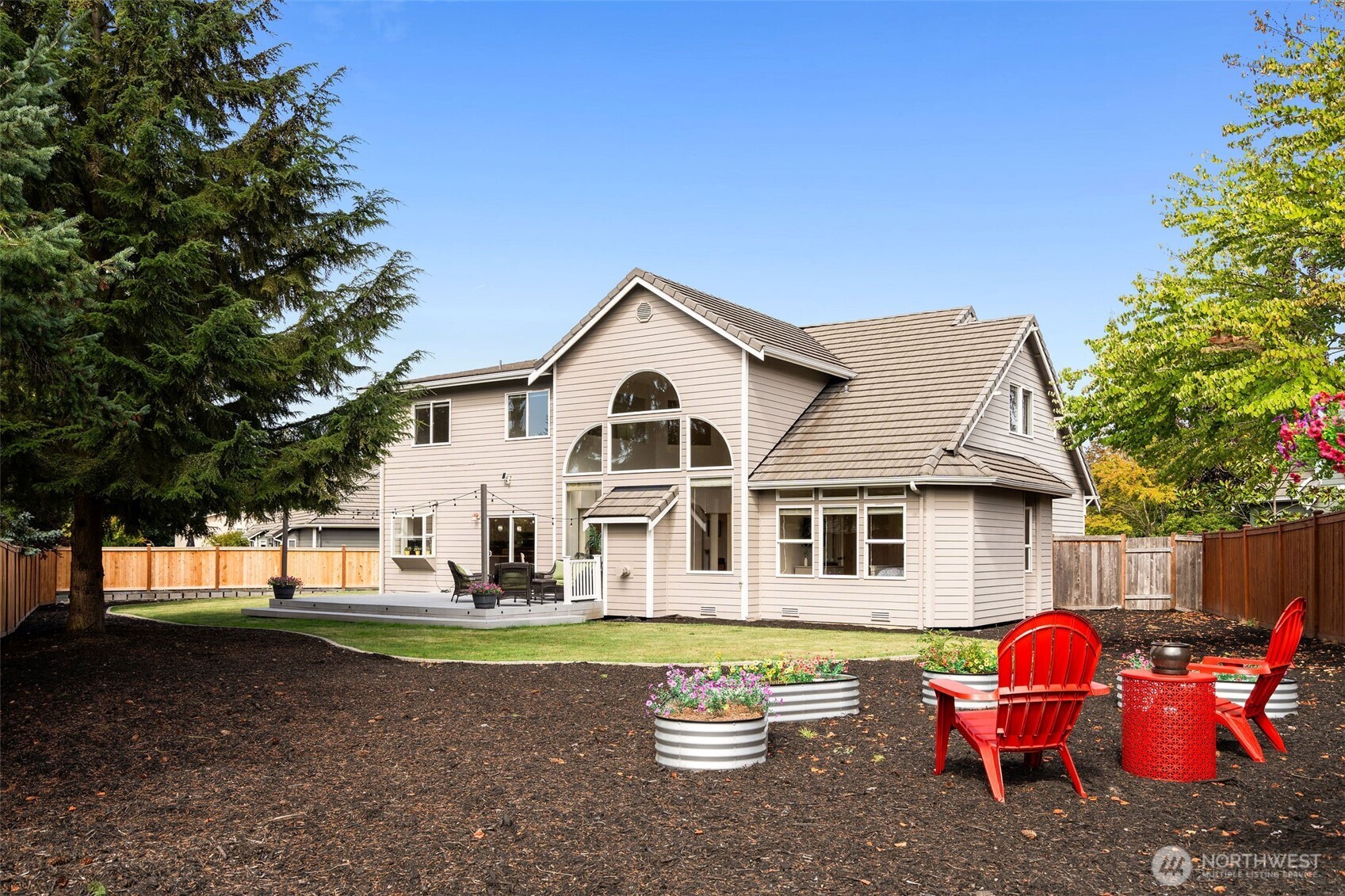 8425 Smugglers Cove Lane Mukilteo, WA 98275 - Photo 33 of 40 a front view of a house with a garden and trees