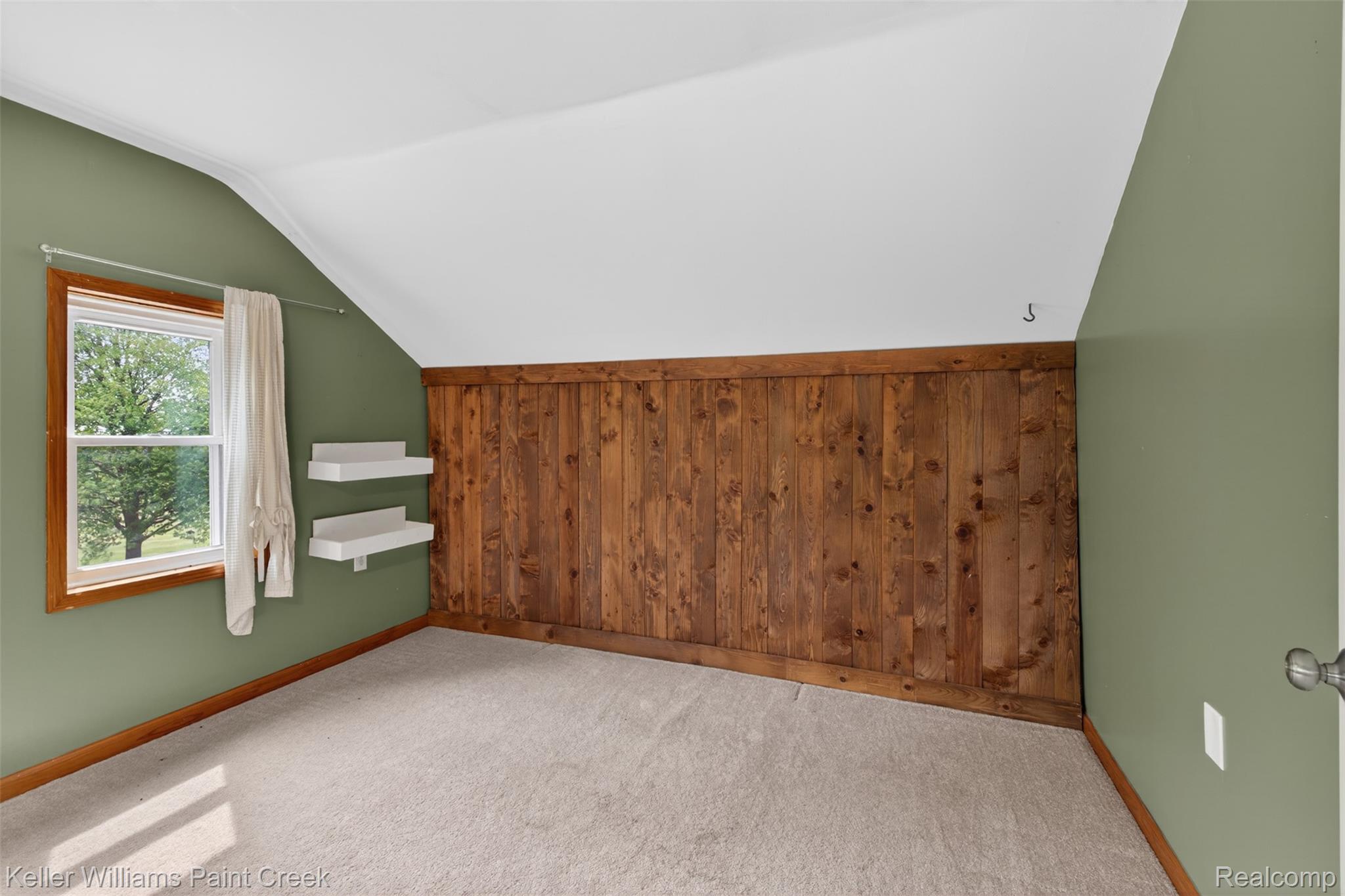 18125 Nelson Road St. Charles, MI 48655 - Photo 31 of 63 Additional living space featuring wooden walls, carpet floors, and vaulted ceiling