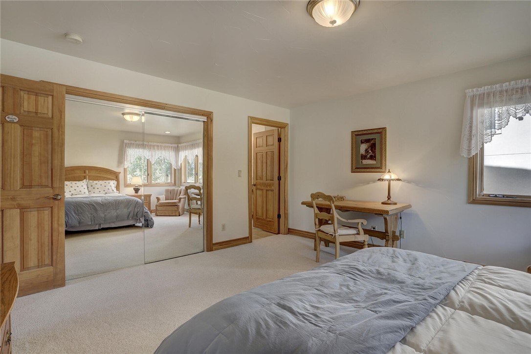 137 Rasor Drive Keystone, CO 80435 - Photo 12 of 35 a bedroom with a bed and a lamp on dresser