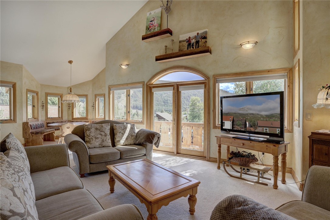 137 Rasor Drive Keystone, CO 80435 - Photo 17 of 35 a living room with furniture a flat screen tv and a floor to ceiling window