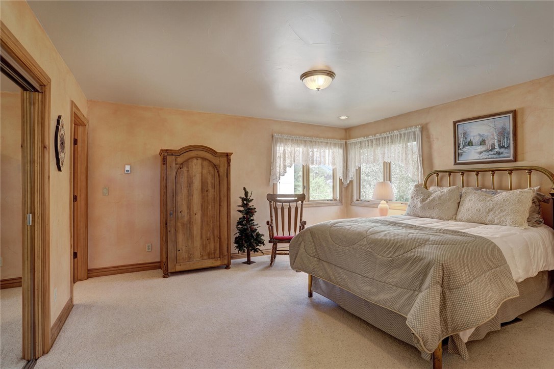 137 Rasor Drive Keystone, CO 80435 - Photo 22 of 35 a spacious bedroom with a bed and a dresser