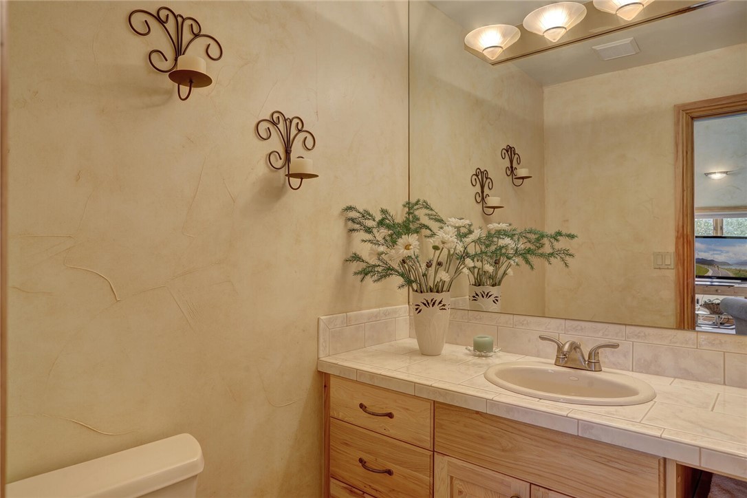 137 Rasor Drive Keystone, CO 80435 - Photo 26 of 35 a bathroom with a granite countertop sink and a mirror