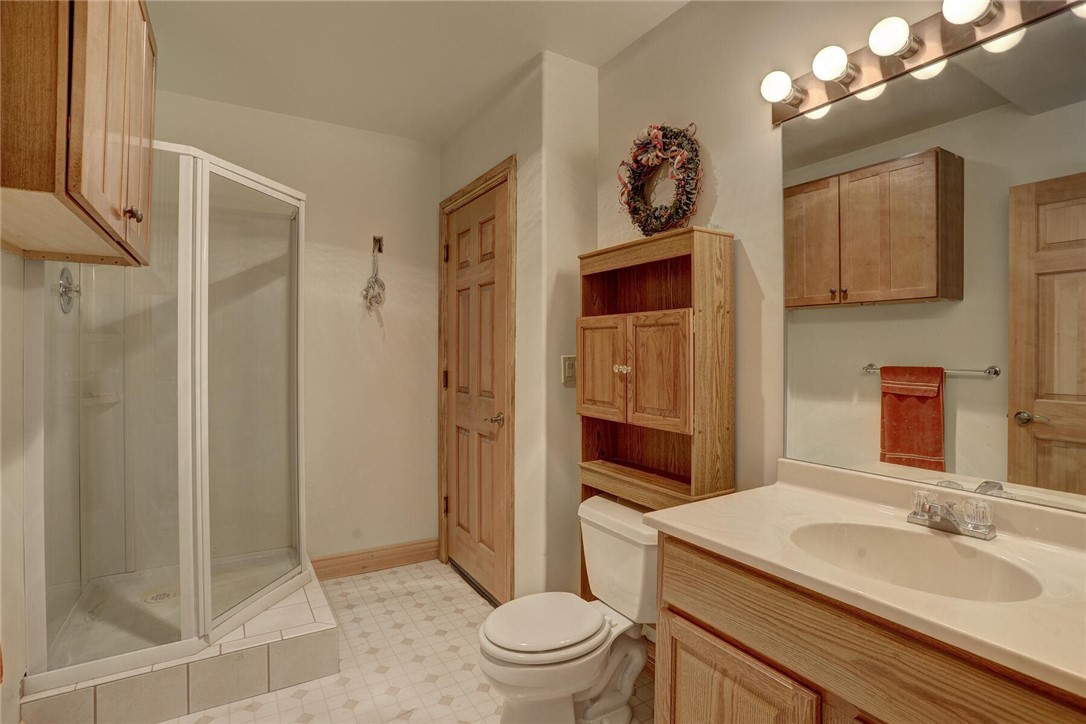137 Rasor Drive Keystone, CO 80435 - Photo 34 of 35 a spacious bathroom with a granite countertop sink a toilet a mirror and shower