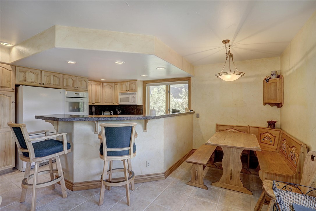 137 Rasor Drive Keystone, CO 80435 - Photo 7 of 35 a kitchen with kitchen island a view of living room and chairs