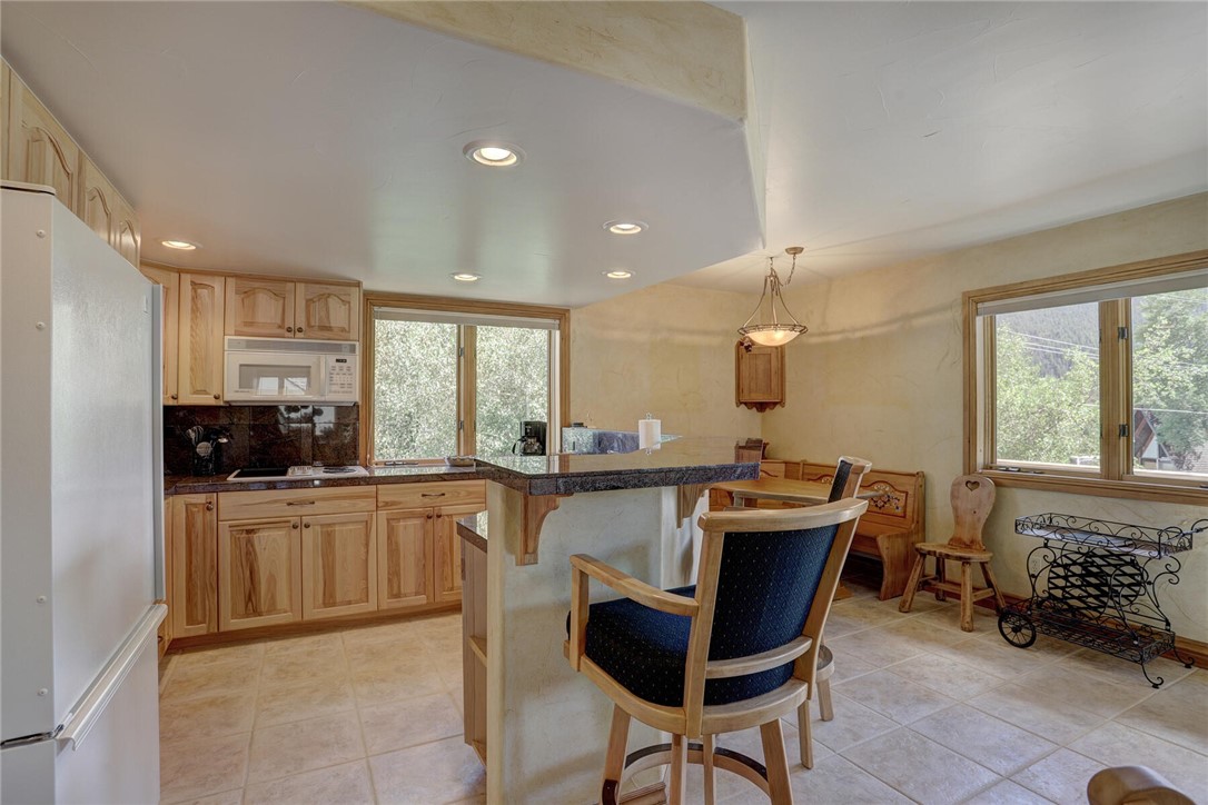 137 Rasor Drive Keystone, CO 80435 - Photo 8 of 35 a kitchen with stainless steel appliances kitchen island granite countertop a sink and cabinets