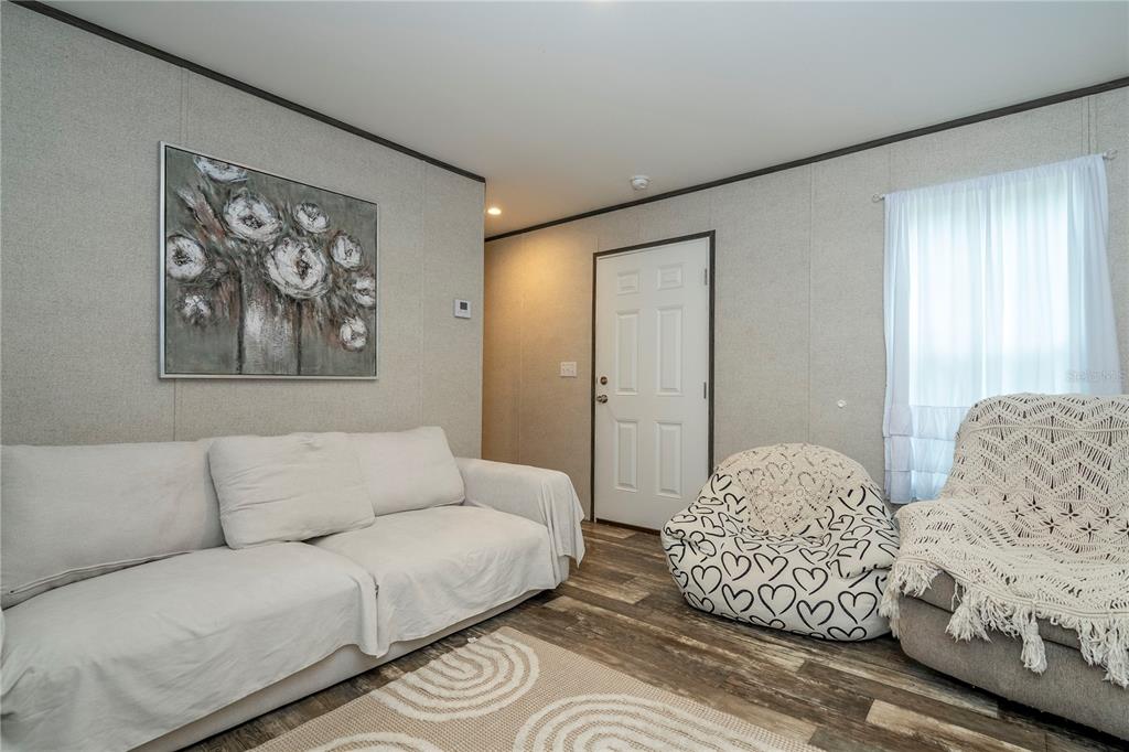 36720 Emeralda Island Road Leesburg, FL 34788 - Photo 11 of 43 a living room with furniture and a large window