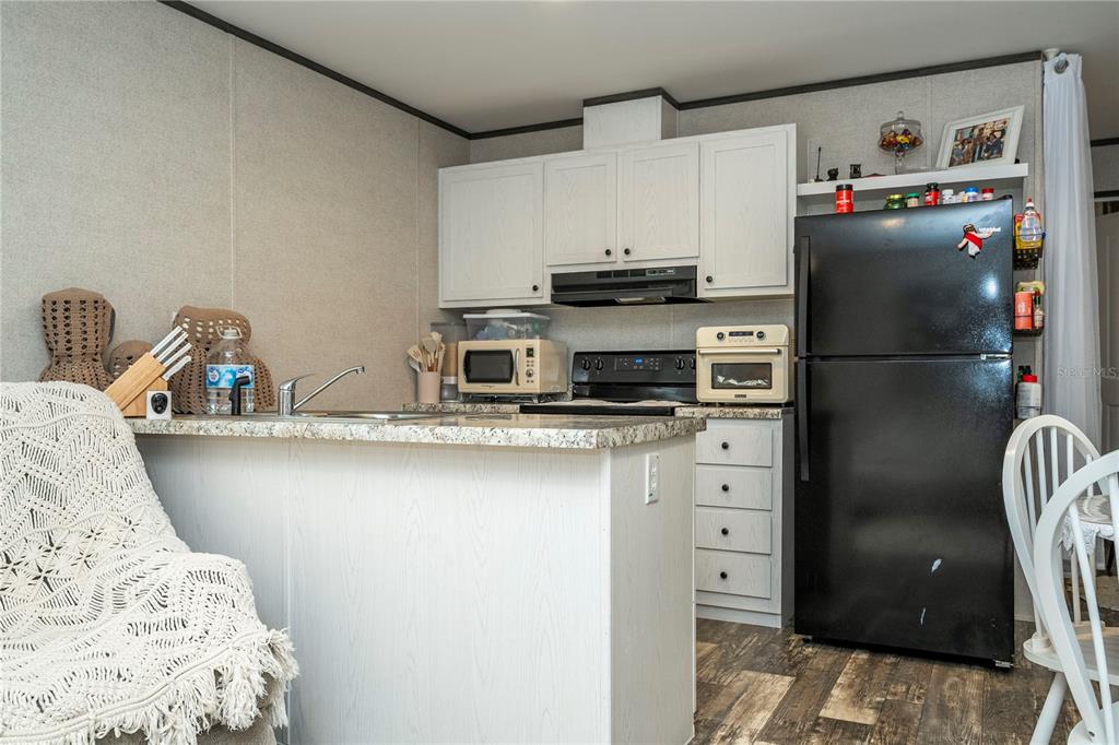 36720 Emeralda Island Road Leesburg, FL 34788 - Photo 15 of 43 a kitchen with stainless steel appliances a refrigerator and a stove